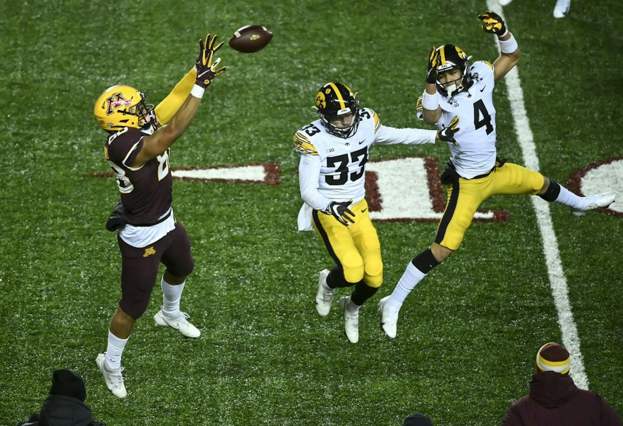Minnesota Gophers tight end Brevyn Spann-Ford (88) caught a pass for a first down as he was defended by Iowa Hawkeyes defensive back Riley Moss (33) and defensive back Dane Belton (4) in the third quarter. The play was reversed because the Gophers called a timeout before the snap.