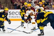 Gophers forward Jimmy Snuggerud draws the attention of the Michigan defense during Minnesota's 6-2 win on Friday. Snuggerud leads the Gophers with 19 