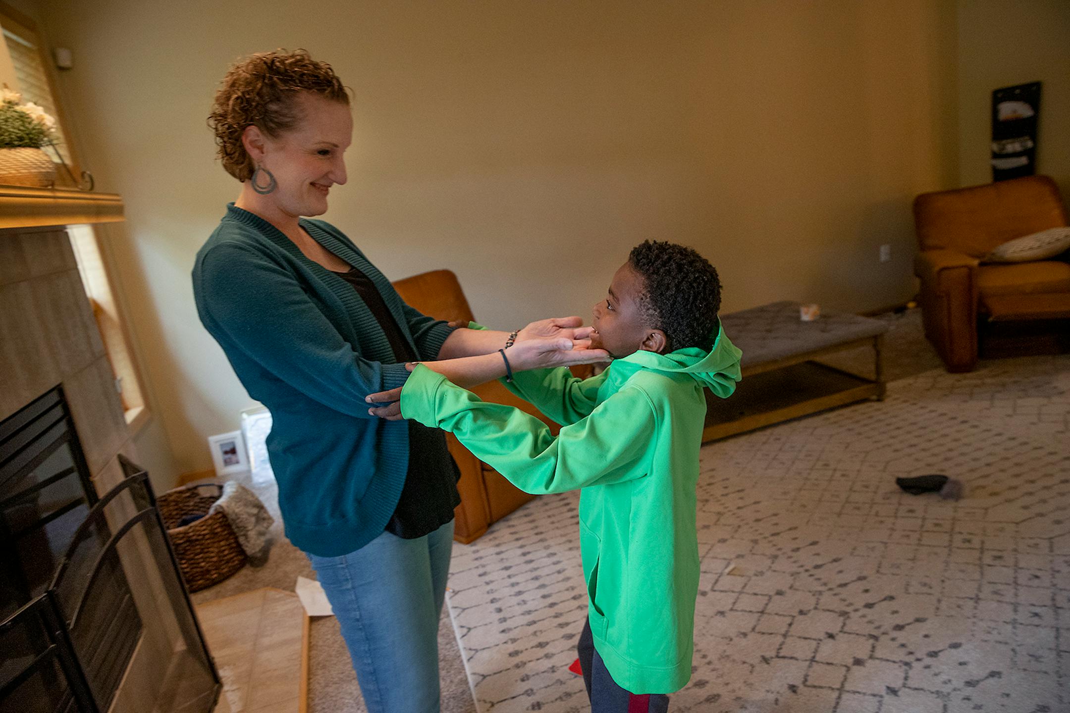Kate Lundquist gave her son Maki, 8, affection as he took a break from on-line class, Tuesday, September 29, 2020 in Brooklyn Park, MN.