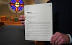 Pastor Joel Wight Hoogheem was photographed inside Lord of Life Lutheran Church in Maple Grove, Minn. as he held a copy of one of the letters of debt 