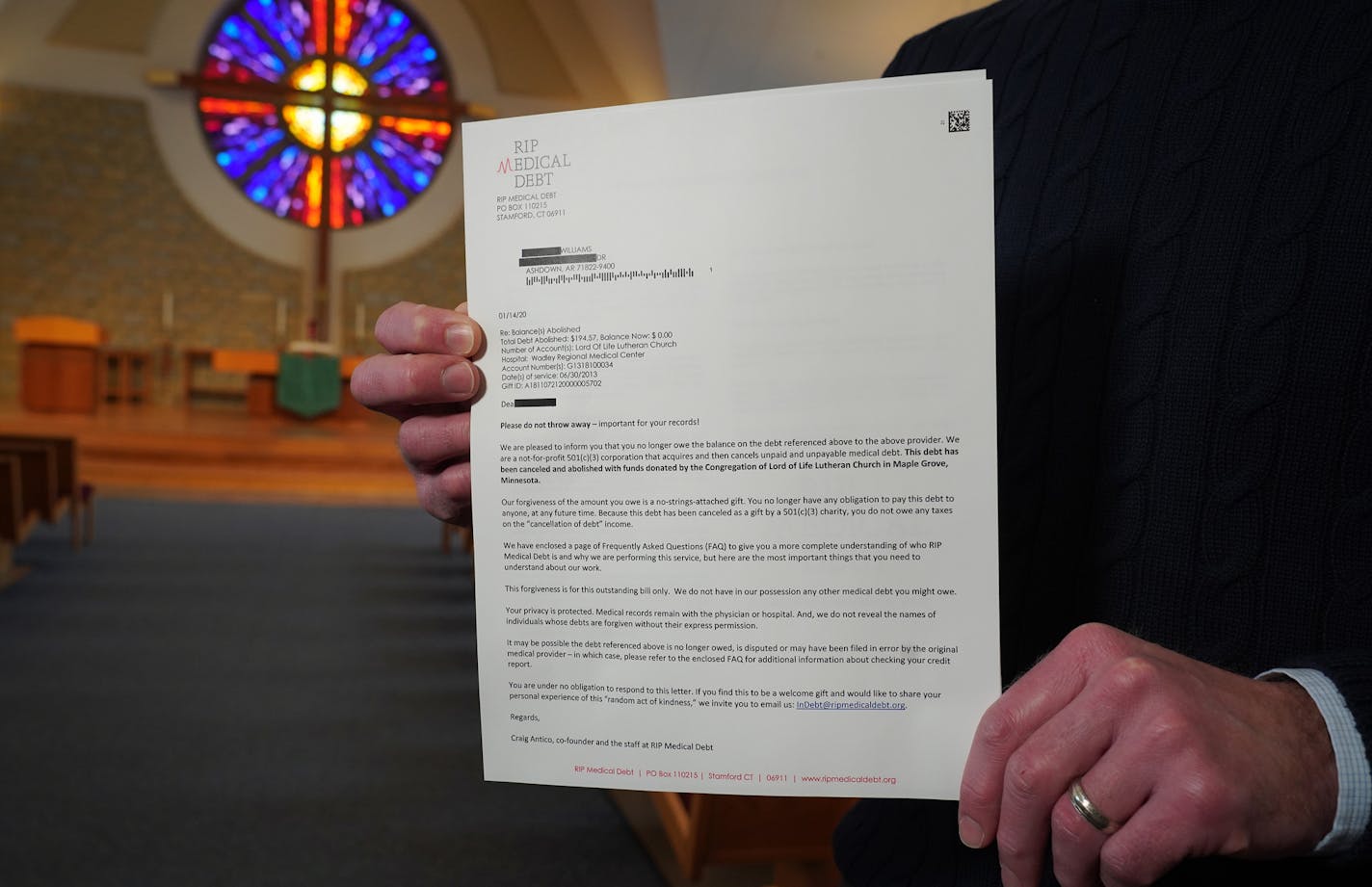 Pastor Joel Wight Hoogheem was photographed inside Lord of Life Lutheran Church in Maple Grove, Minn. as he held a copy of one of the letters of debt forgiveness that were sent out to more than 400 people. ] Shari L. Gross &#x2022; shari.gross@startribune.com The surprise letters arrived in the mailboxes of more than 400 low income residents of Texas and Arkansas, all in debt over medical bills. After a brief introduction, the letter states: "This debt has been cancelled and abolished by funds d