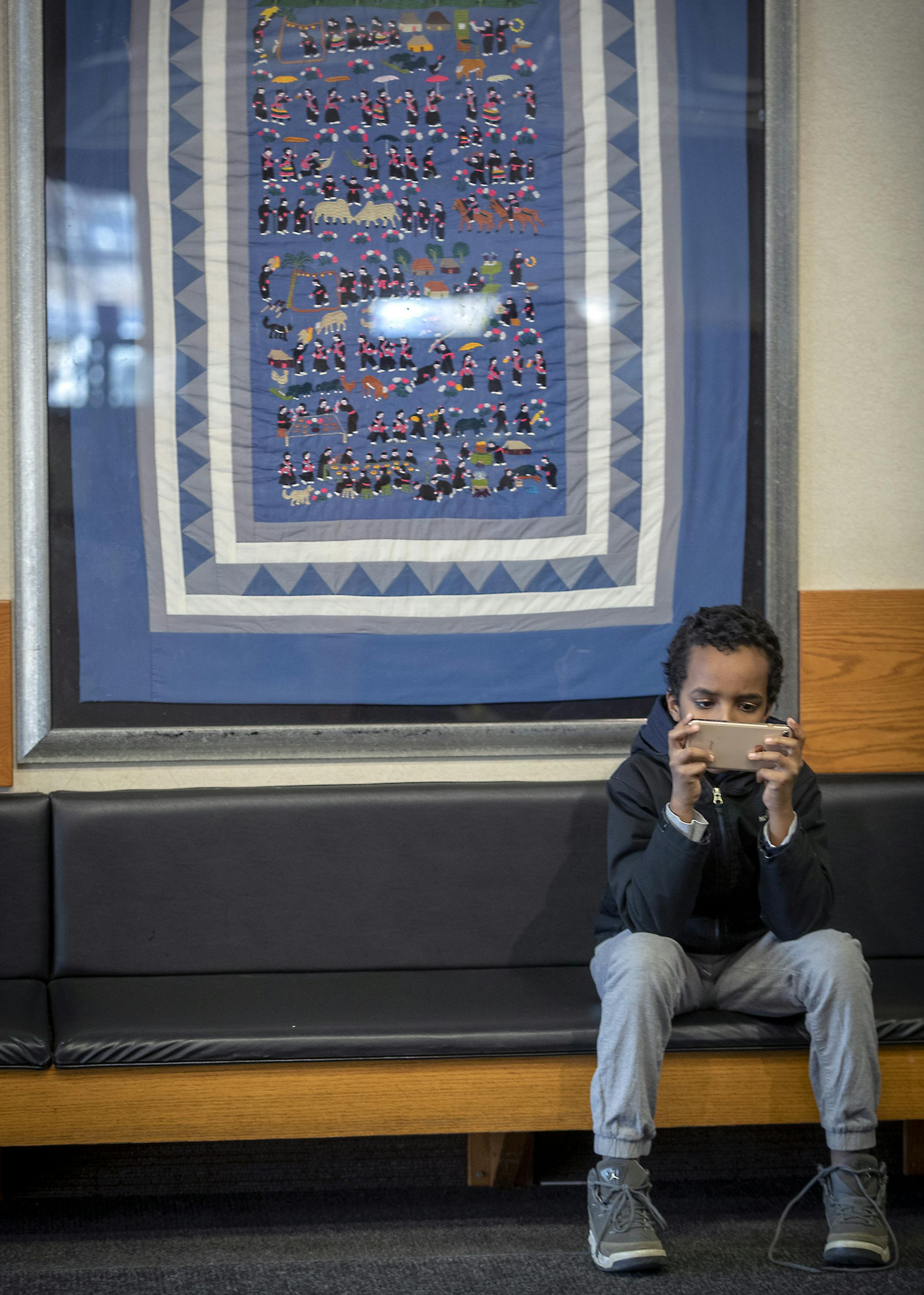 A Hmong storyboard on the wall is one of the first pieces of art that customers see at at the Prosperity Wells Fargo branch, Friday, January 11, 2019. The branch, on the East Side of St. Paul, is one of the bank's busiest branches in the country with many of its customers being from immigrant populations and most of its bank workers speaking multiple languages. ] ELIZABETH FLORES • liz.flores@startribune.com