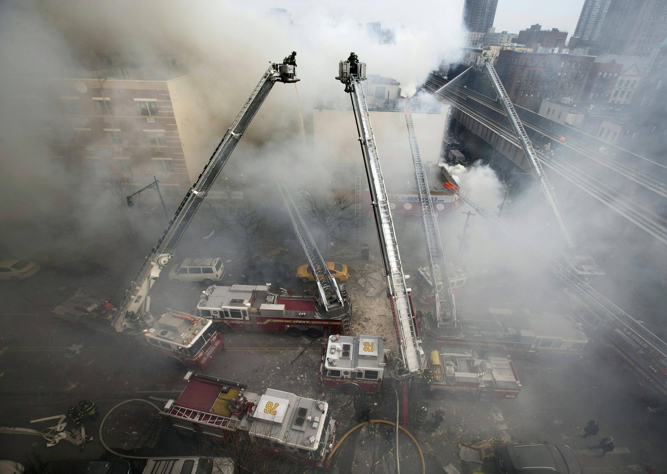 Firefighters respond to an explosion that leveled two apartment buildings in the East Harlem neighborhood of New York, Wednesday, March 12, 2014.