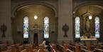 The Basilica of St. Mary in Minneapolis is celebrating the parish's 150th anniversary. Here, a woman sat in the quiet nave on Thursday, December 6, 20
