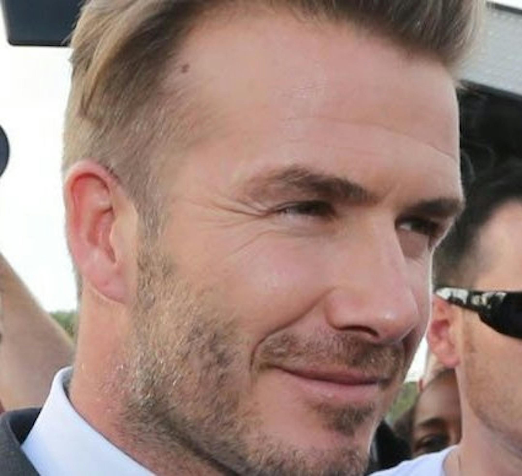 David Beckham attempts to tour the Kendall Soccer Park, but is surrounded by a throng of fans and media on Wednesday, Feb. 5, 2014, in Miami. (Al Diaz/Miami Herald/MCT)