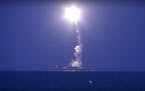 In this photo made from the footage taken from Russian Defense Ministry official web site, Wednesday, Oct. 7, 2015, a Russian navy ship launches a cru