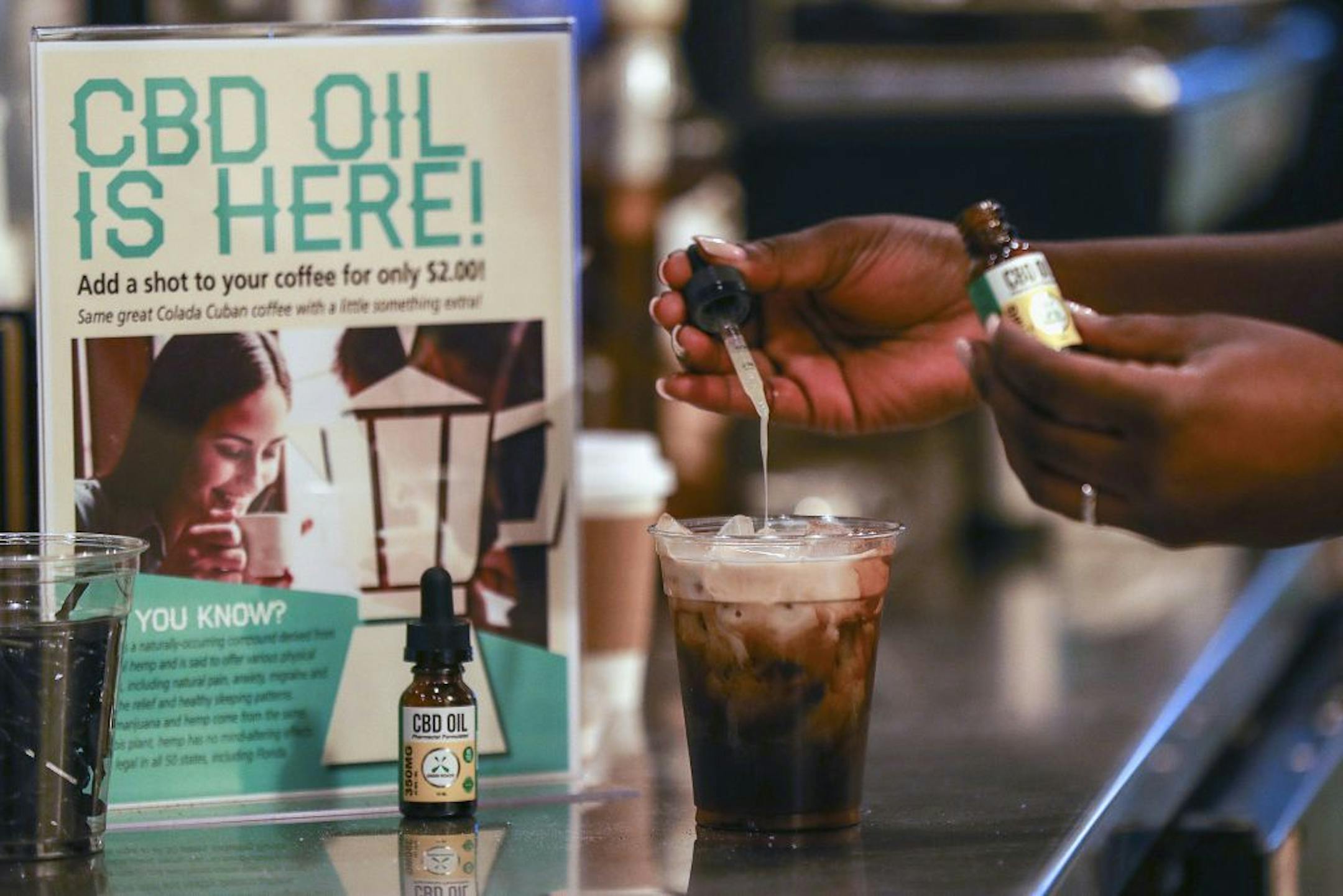 FILE - In this Jan. 4, 2018, file photo, a worker adds cannabidiol (CBD) to a drink at a coffee shop in Fort Lauderdale, Fla.