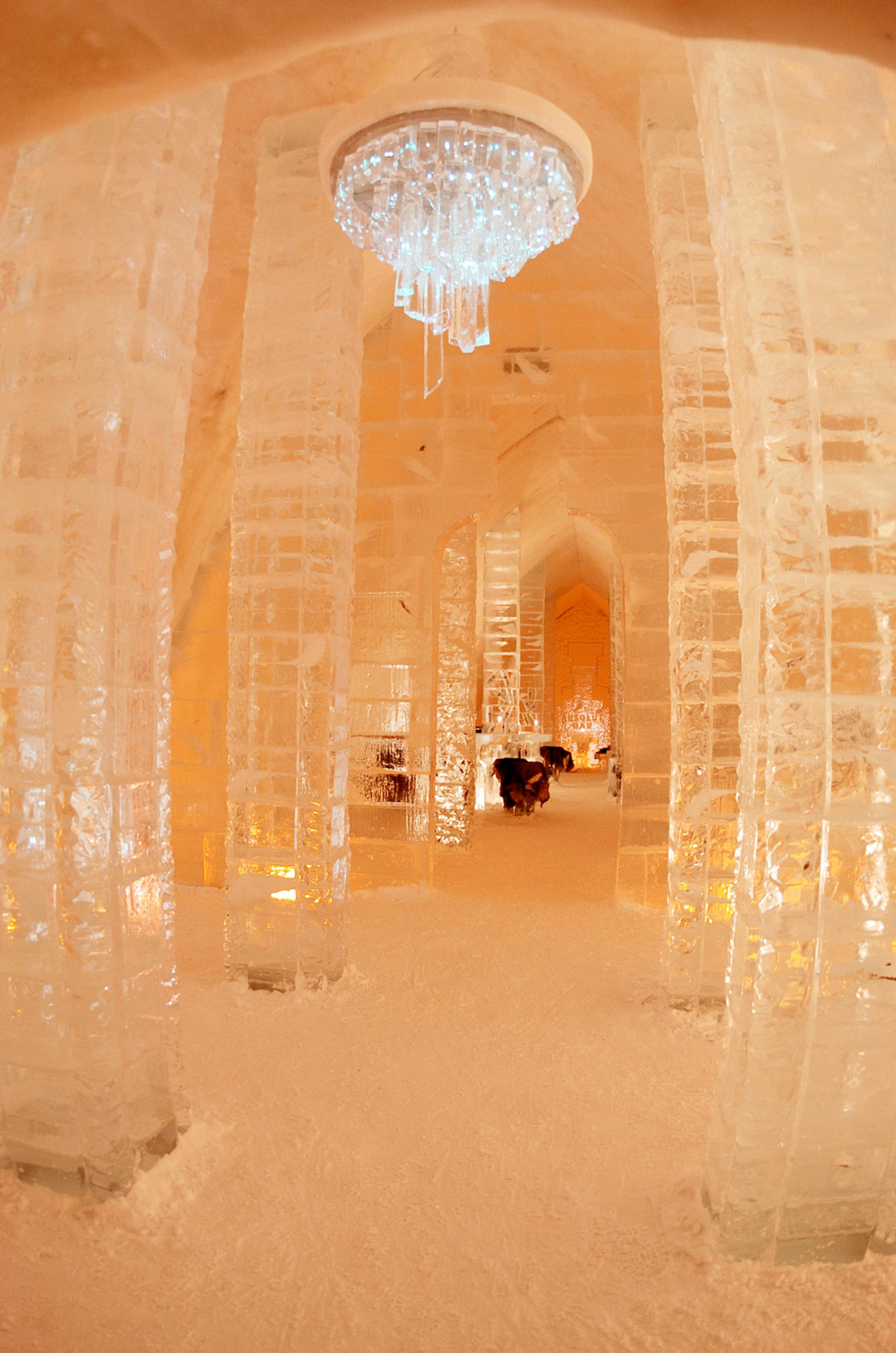 The Ice Hotel's gorgeous lobby sparkles under a fiber optic-lit candelabrum. More than 65,000 visitors pay about $15 (CAD) just to take a tour.