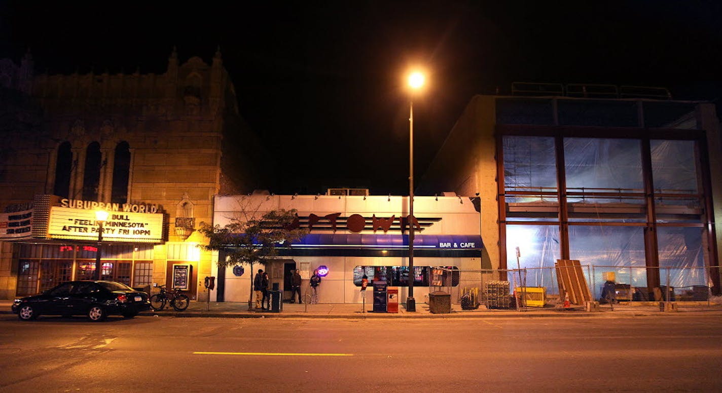 Redevelopment is squeezing the Uptown Bar (center), with a new building rising next door. The bar will be razed to make way for another two-story retail space.