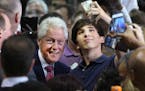 Former President Bill Clinton, left, poses for a selfie as he campaigns for his wife, Democratic presidential candidate Hillary Clinton, Sept. 7, 2016