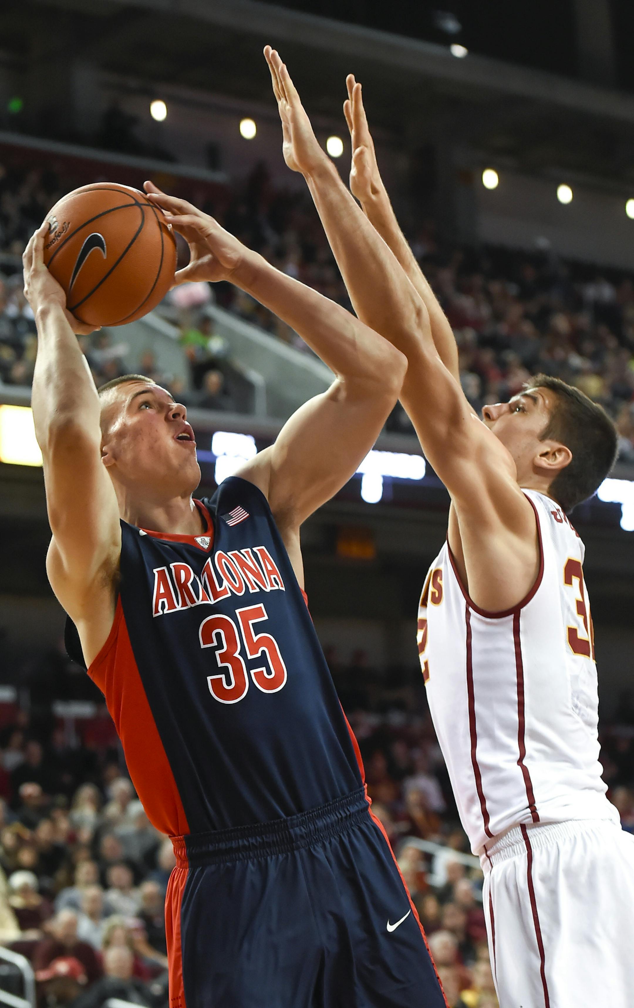 Arizona center Kaleb Tarczewski (35) posts up to shoot over Southern California forward Nikola Jovanovic (32) during the first half of an NCAA college basketball game, Saturday, Jan. 9, 2016, in Los Angeles. (AP Photo/Gus Ruelas)