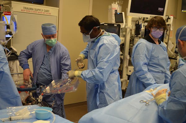 Mayo Clinic doctors and emergency specialists practiced hooking an ECMO machine onto a dummy during a drill in January at St. Marys Hospital in Roches