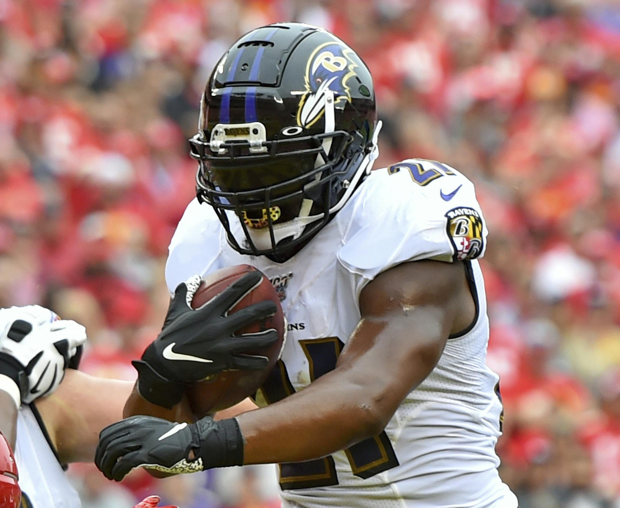 Baltimore Ravens running back Mark Ingram II (21) runs the ball in for a touchdown between Kansas City Chiefs linebacker Damien Wilson, left, and defensive end Alex Okafor (97) during the first half of an NFL football game in Kansas City, Mo., Sunday, Sept. 22, 2019. (AP Photo/Ed Zurga)