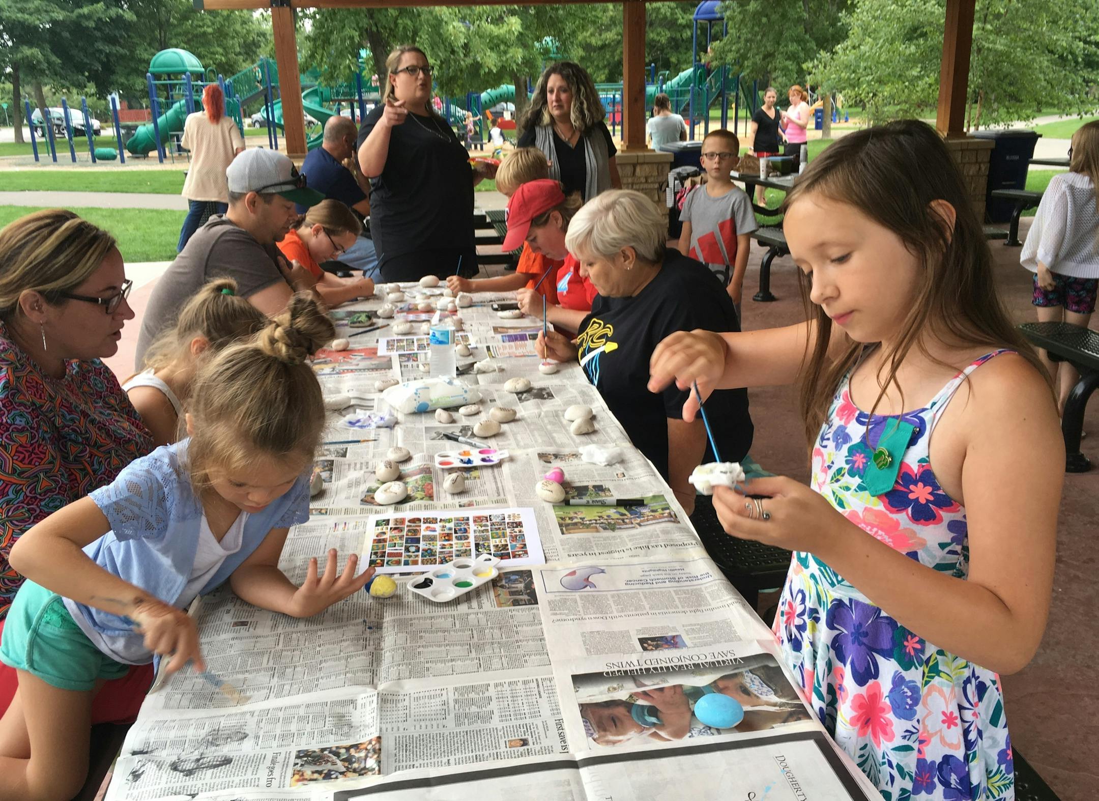 Alyx Gerhart, 9, decorates a rock at a recent painting party her Girl Scout troop hosted in Champlin.