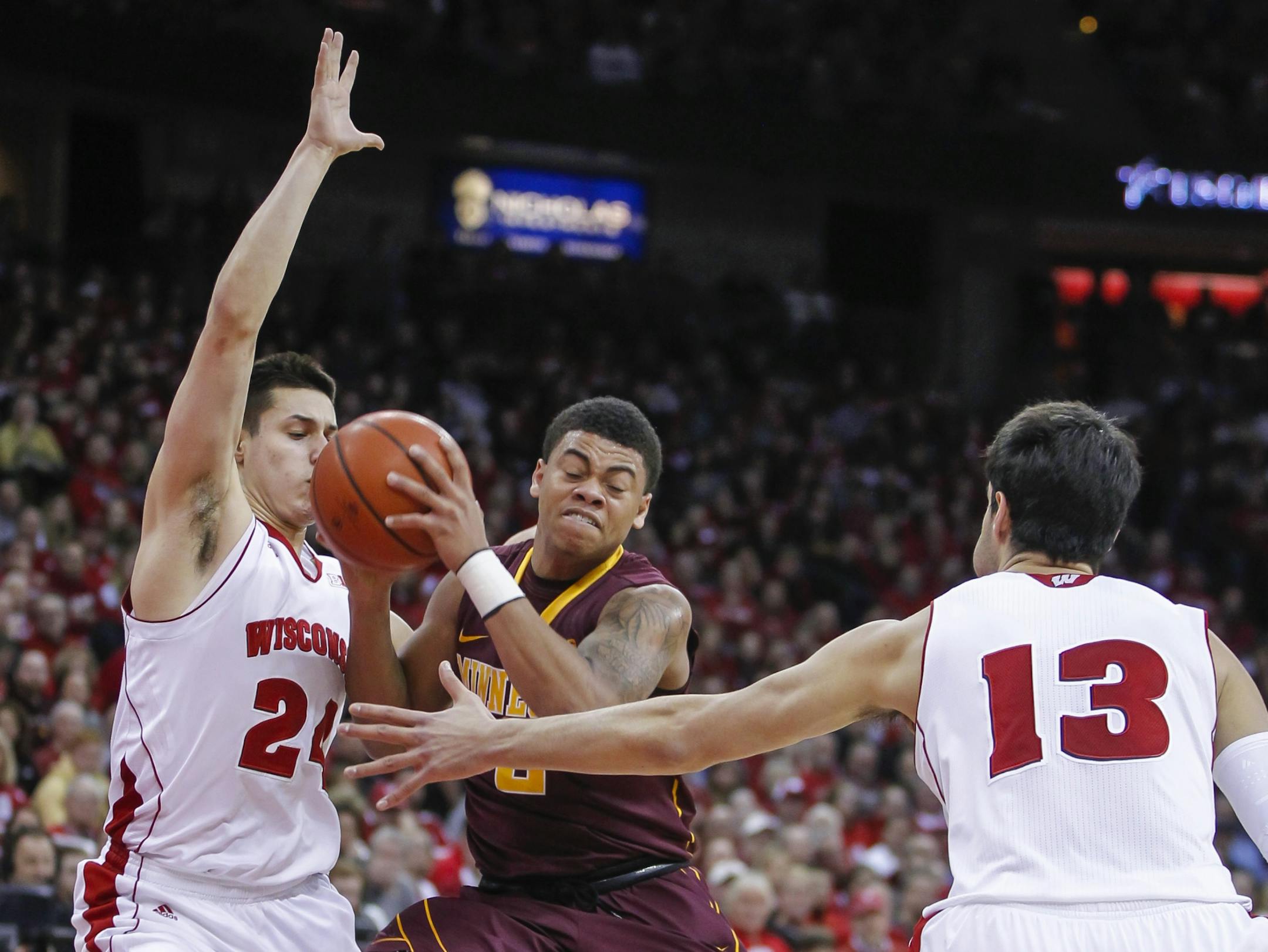 Gophers freshman Nate Mason, center, battled between Wisconsin's Bronson Koenig, left, and Duje Dukan (21) during a Feb. 21, 2015, game in Madison, Wis.
