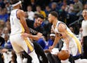 Wolves guard Ricky Rubio, center, tried to fight throug a pick set by Golden State's JaVale McGee as the Warriors' Stephen Curry, right, drove by.