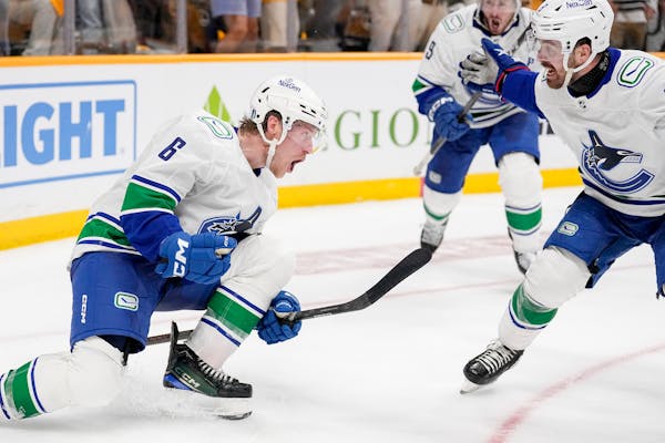 Vancouver Canucks right wing Brock Boeser (6) celebrates his game tying goal with right wing Conor Garland, right, late in the third period against th