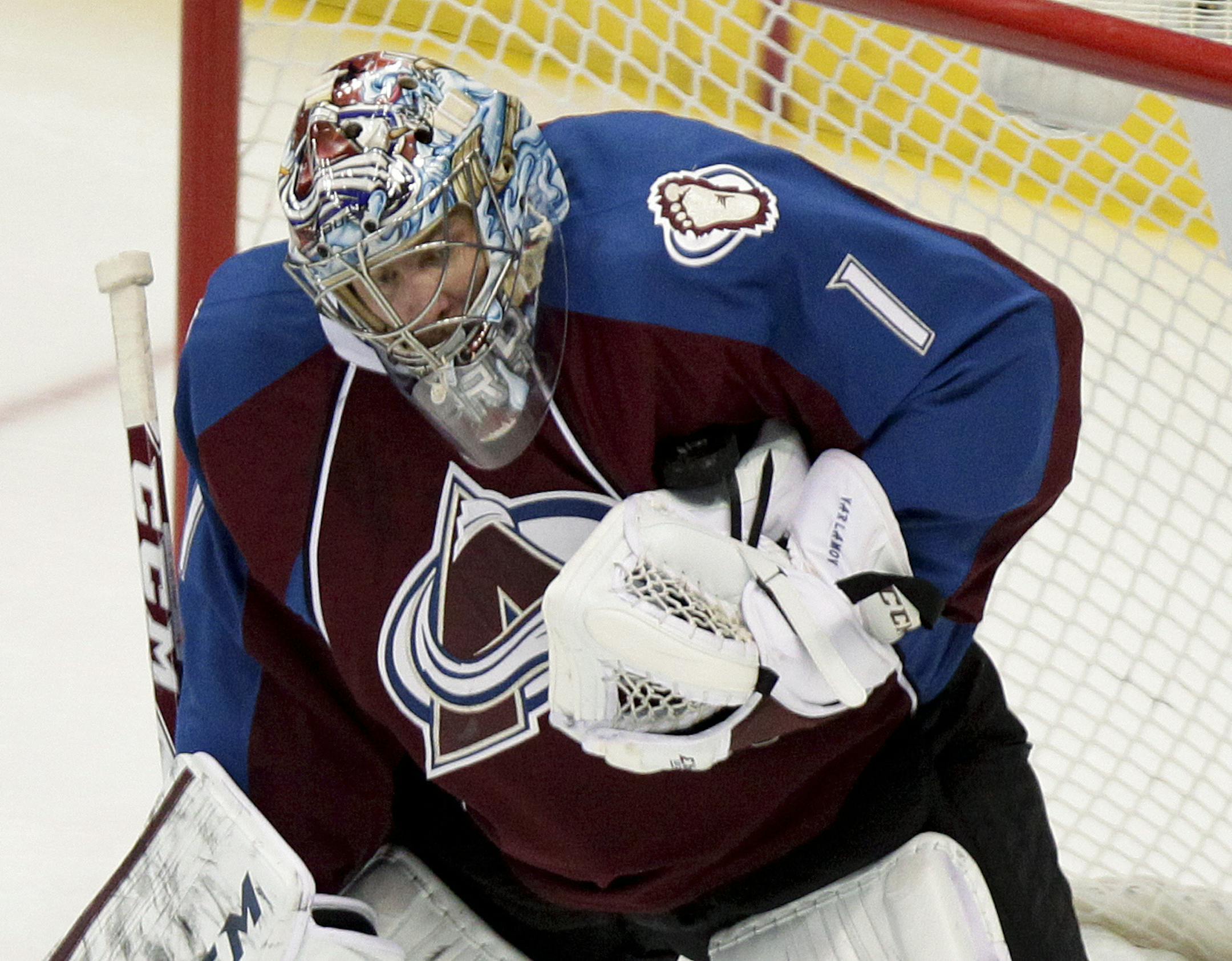 Colorado Avalanche goalie Semyon Varlamov (1), of Russia, makes a save against the Minnesota Wild during the first period of an NHL hockey game Thursday, Jan. 30, 2014, in Denver. (AP Photo/Barry Gutierrez)