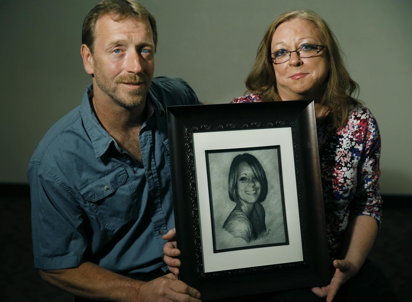 Kira Trevino's parents, Jay and Marcie Steger, hold a sketch of their daughter.