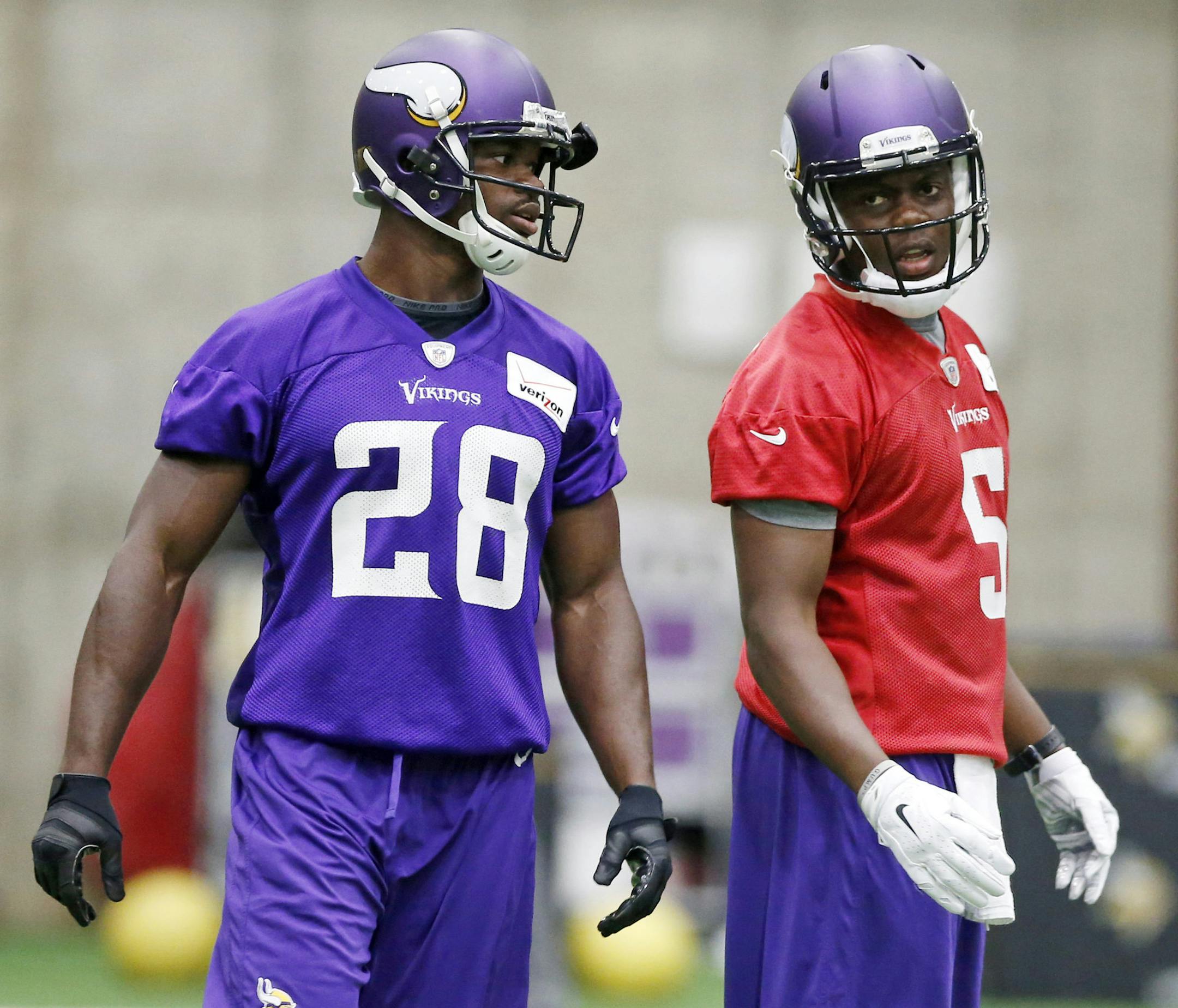 Minnesota Vikings quarterback Teddy Bridgewater, right, and running back Adrian Peterson talk during NFL football practice, Thursday, June 11, 2015, in Eden Prairie, Minn. (AP Photo/Jim Mone)