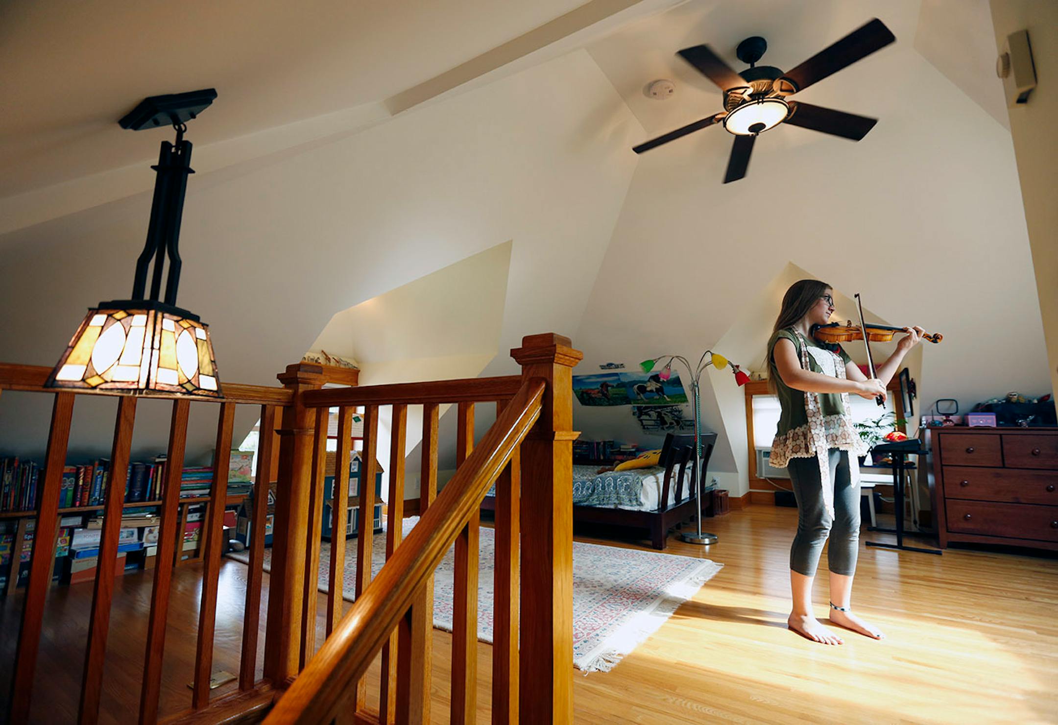 Margaret Durant practices her violin in her super-private attic bedroom created on the third floor of her 1909 Craftsman foursquare.