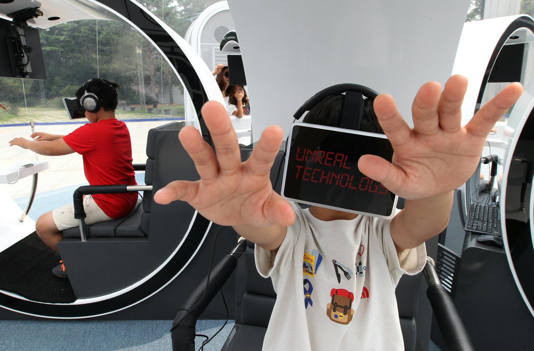 Children wearing the Oculus Rift virtual reality headsets, experience virtual reality technology at the experience hall "T.um mobile" of SK Telecom's Information and Communications Technology, or ICT, in Seoul, South Korea, Friday, Aug. 22, 2014. SK Telecom, the largest mobile carrier in South Korea, opened Wednesday the hands-on experience center where children can learn about the history and latest trends of information and communications technology in Seoul.