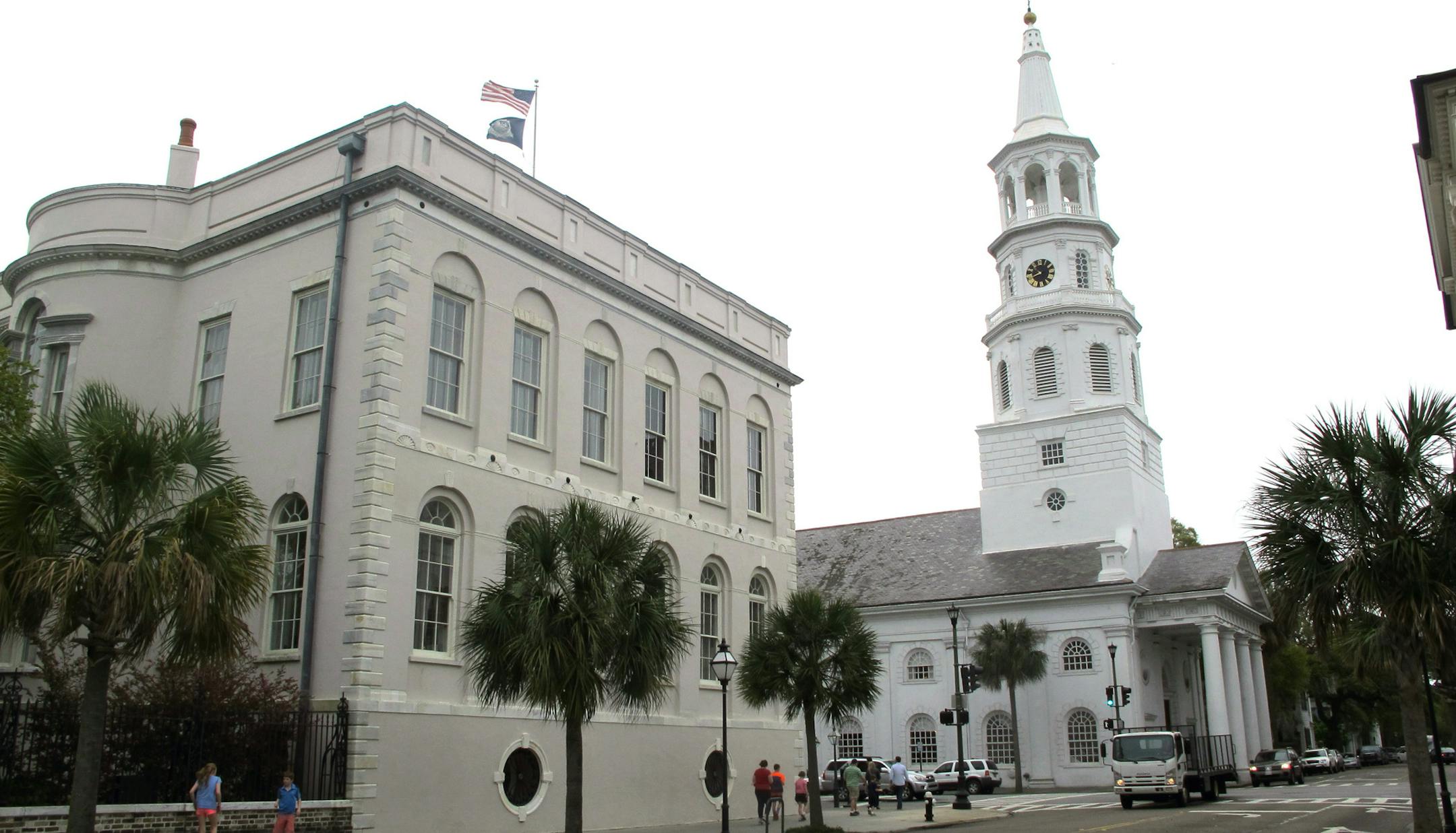 April 7, 2014: Pedestrians walk by City Hall and St. Michael's Episcopal Church in Charleston, S.C.