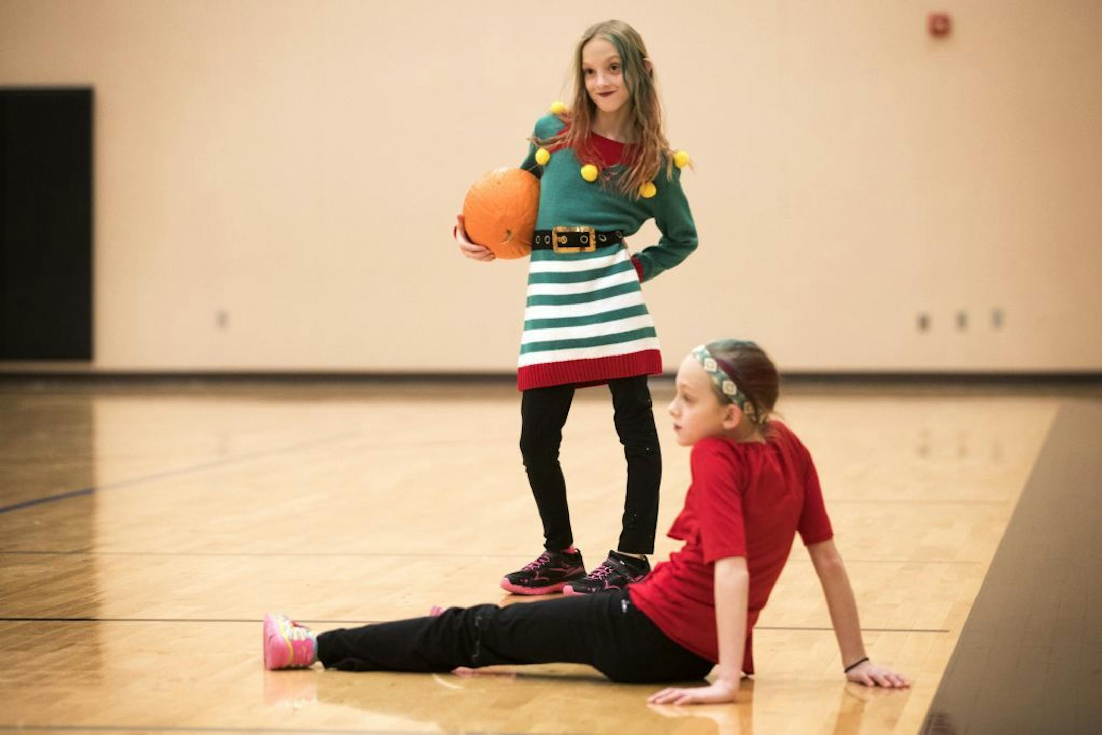 Abby Carlsen, standing, smiles after she knocked her sister Isabelle out at a game of dodgeball during gym class.