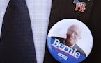 Julio Salazar, from Morristown, Tenn., a supporter of Democratic presidential candidate, Sen. Bernie Sanders, I-Vt, wears a suit coat and tie with a S