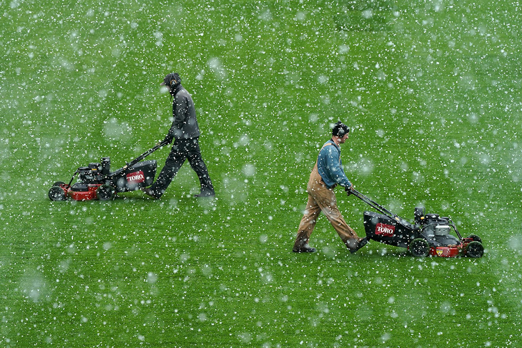 Members of the grounds crew cut the grass at Allianz Field amid heavy snow flurries on Friday, April 12, 2019, ahead of Minnesota United FC home opener against the New York City FC.