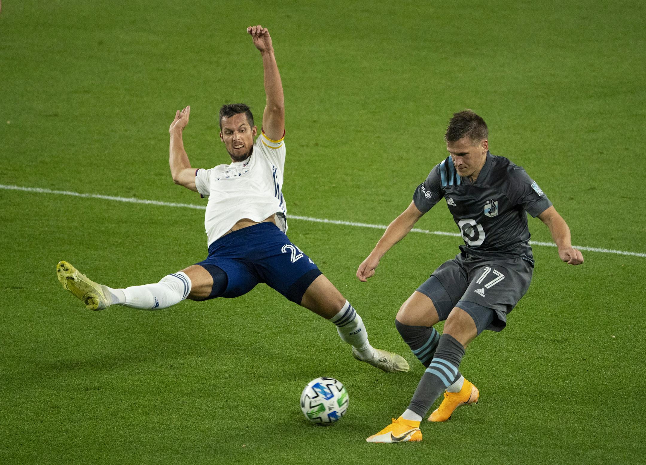FC Dallas defender Matt Hedges (24) reaches to break up a pass by Minnesota United midfielder Robin Lod (17) during the first half of an MLS soccer match, Sunday, Nov. 8, 2020 in St. Paul, Minn. (Jeff Wheeler/Star Tribune via AP)
