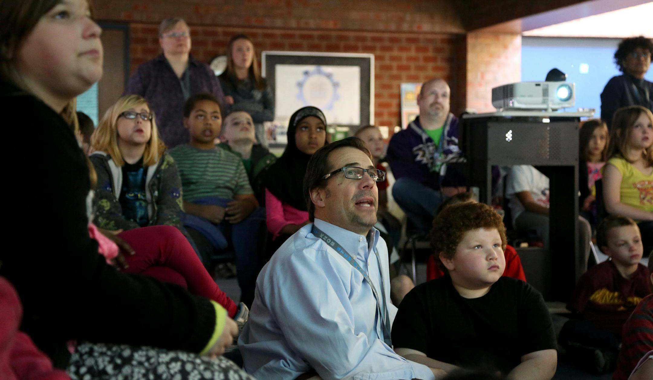 Tom Benson, principal read the final chapters of Elmer and the Dragon by Ruth Stiles Gannet projected on a screen for the students participating in spring break school. ] (KYNDELL HARKNESS/STAR TRIBUNE) kyndell.harkness@startribune.com Pilot Knob Elementary in Eagan Min., Thursday, March 31, 2014.