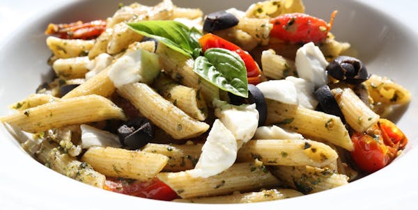 Amp up your pasta with this recipe for penne with pesto, tomatoes and olives. (Patricia Beck/Detroit Free Press/MCT) ORG XMIT: 1157481