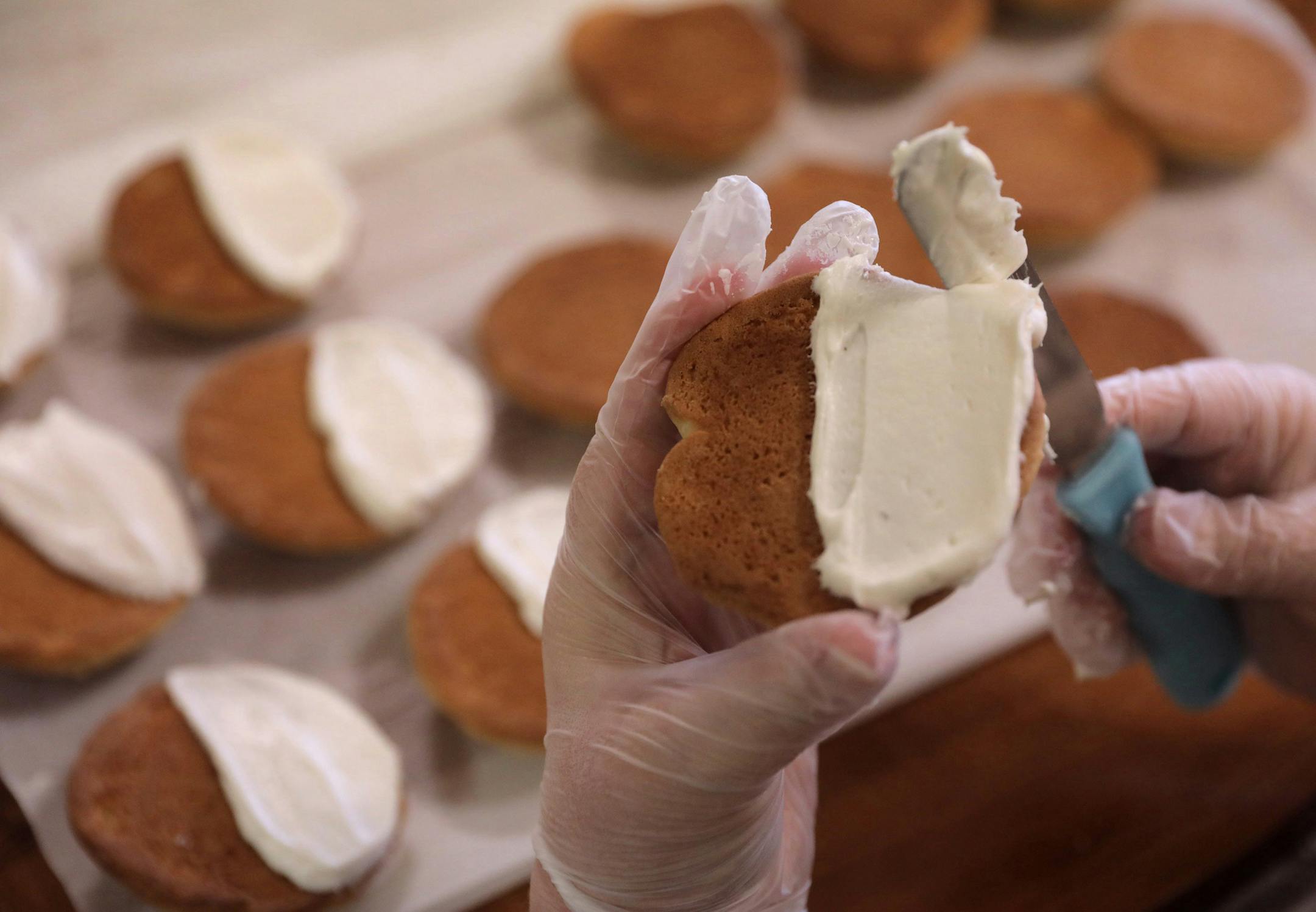 Tina Dimiitry, 49, of St. Louis, ices freshly-made cookies at Laughing Bear Bakery on Wednesday, March 25, 2018. The bakery, located in the kitchen of Centenary United Methodist Church in downtown St. Louis, Mo., offers ex-offenders a paid job and a fresh start. (Cristina M. Fletes/St. Louis Post-Dispatch/TNS)