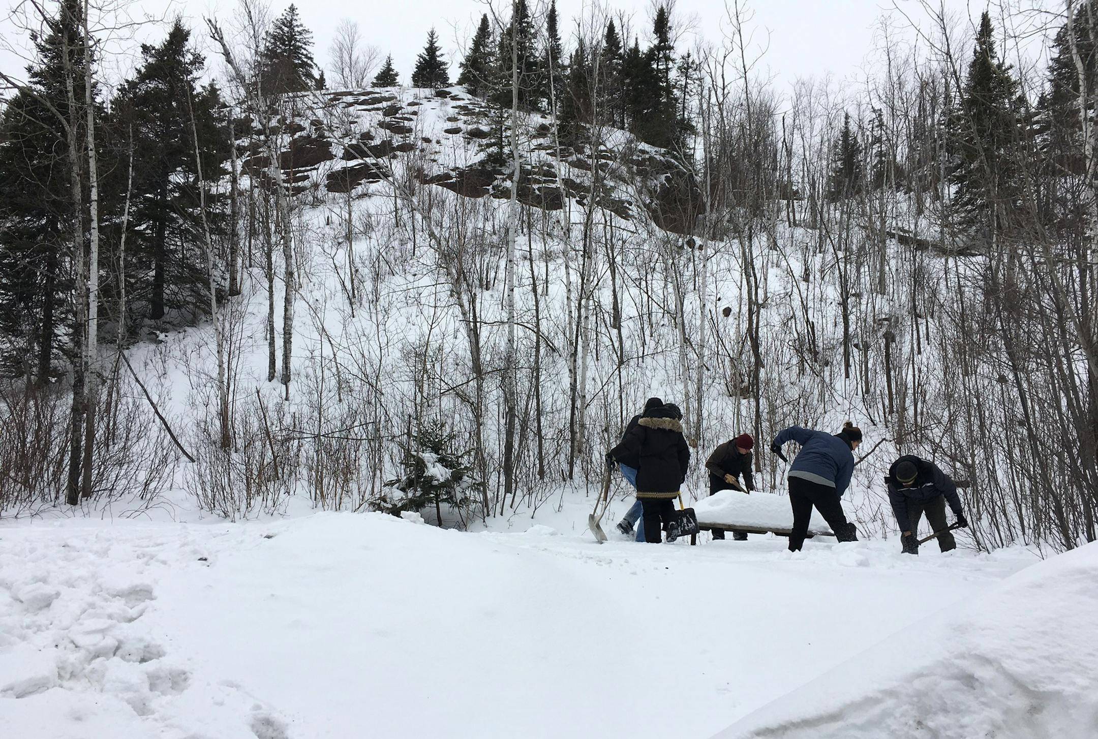 Campers at Tettegouche State Park dug out a cooking area before building their own quinzhees (show shelters) to sleep in.