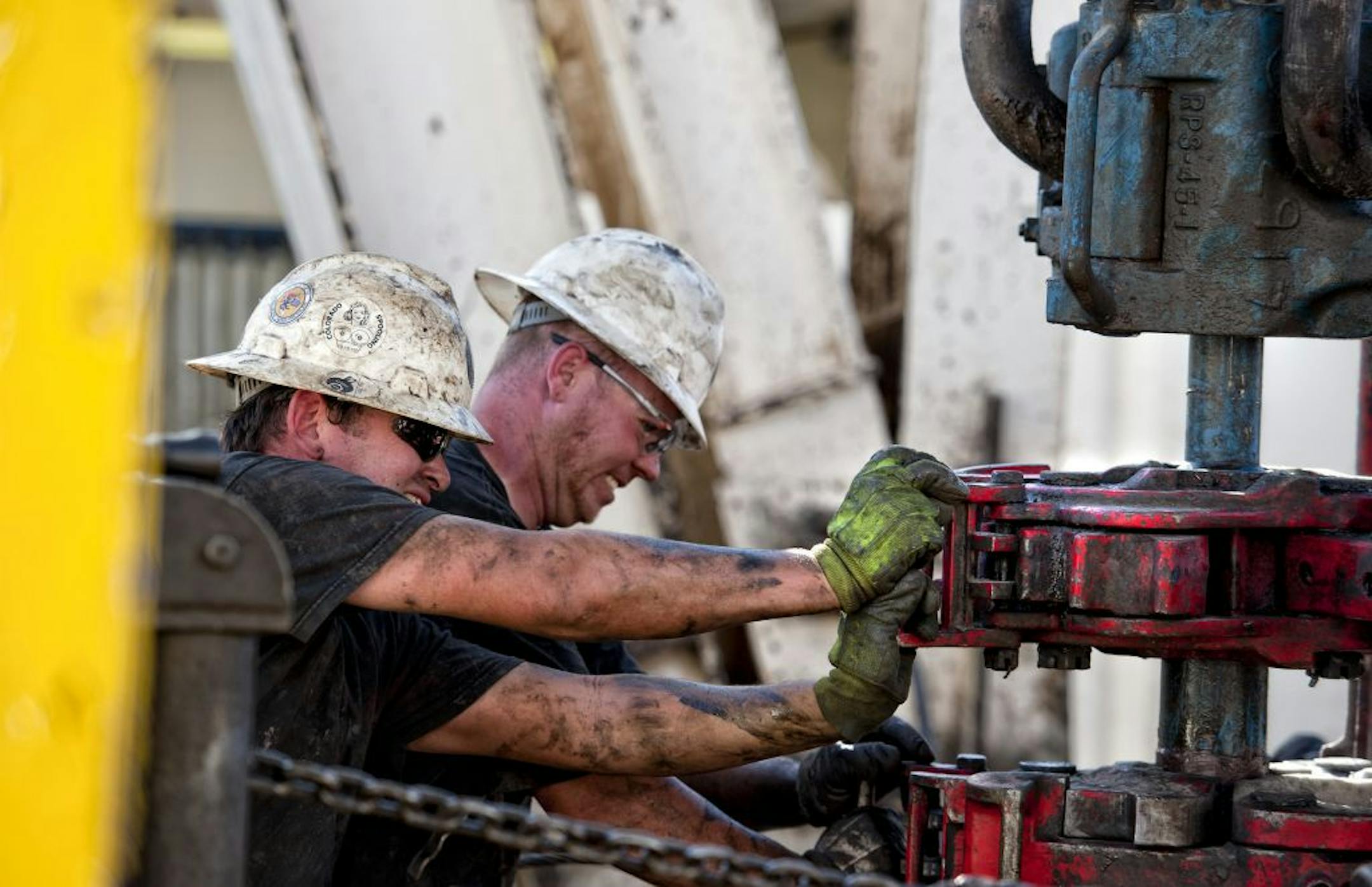 Harmon "Bronc" Jasperson and Brandon Lewis of Kodiak Gas & Oil pulled a drilling pipe from the ground on unit rig 328 near Watford City, N.D.