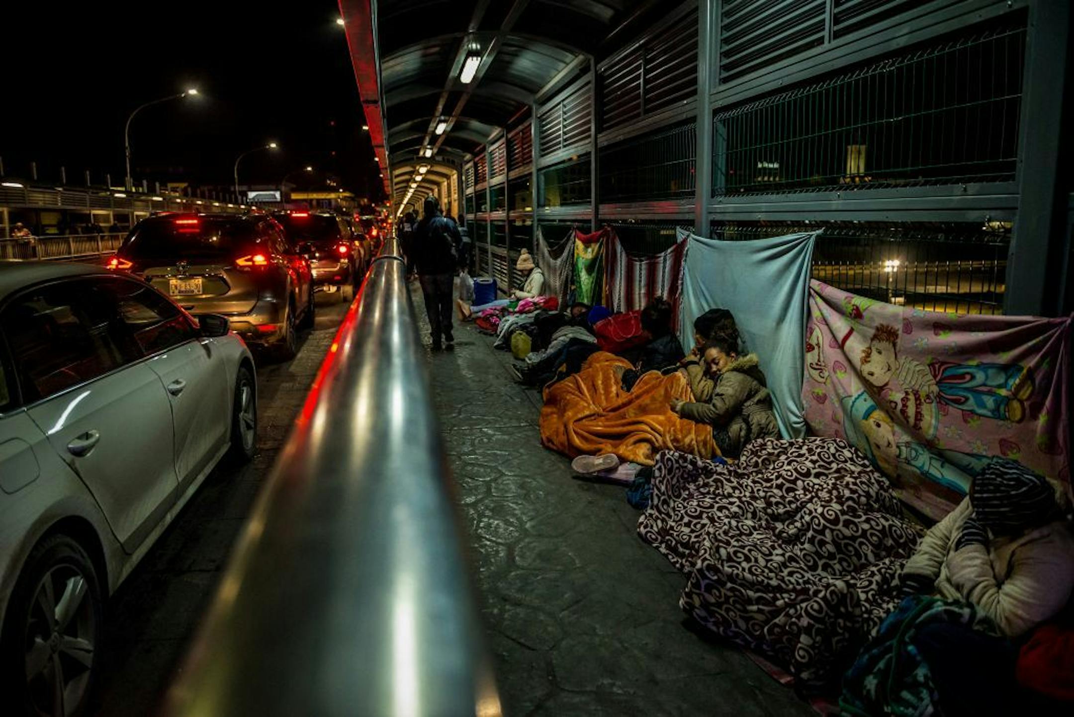 FILE -- Asylum seekers on a bridge linking Laredo, Texas, and Nuevo Laredo, Mexico, Jan. 11, 2019. A federal appeals court said on April 12, 2019 that the Trump administration could temporarily continue to force migrants seeking asylum in the United States to wait in Mexico while their cases are decided.
