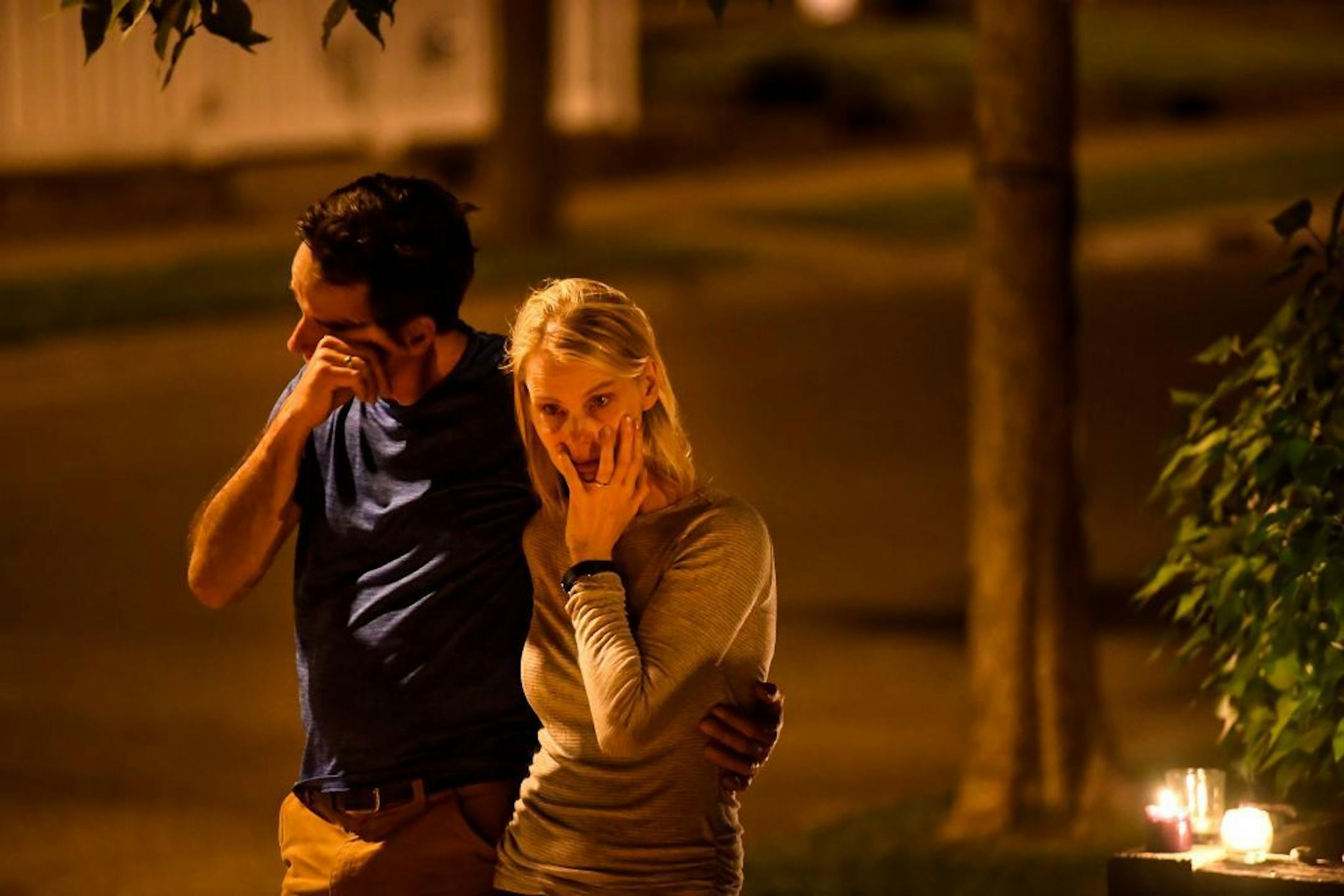 Mindy Barry and her husband, John, friends and neighbors of Don Damond, comforted each other during a candlelight vigil held on the one year anniversary of the shooting death of Justine Damond Ruszczyk by Minneapolis Police officer Mohamed Noor.