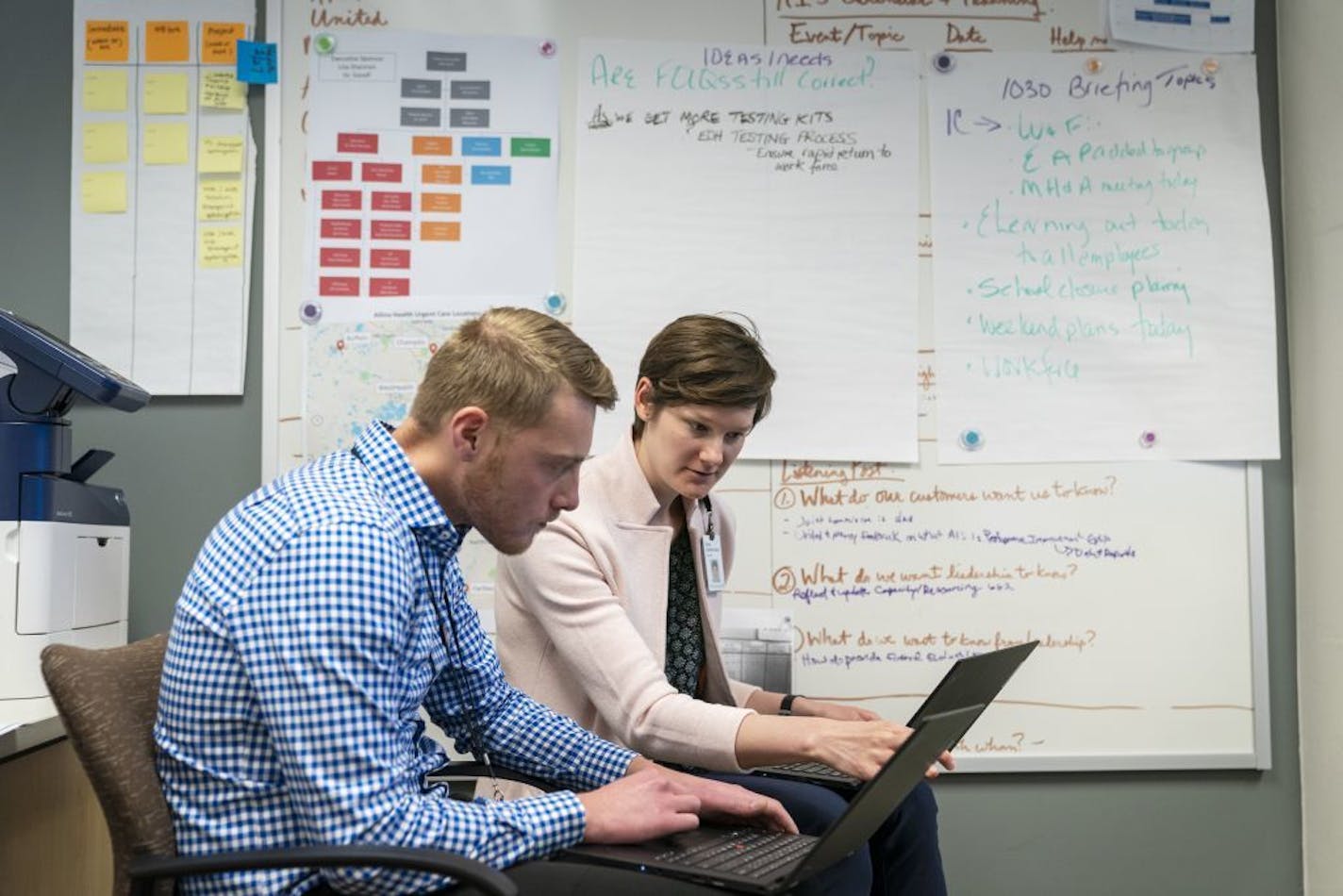 Taylor Bruns, from left, and Kate Selbitschka, both performance improvement advisors for Allina Health, worked in the COVID-19 command center.