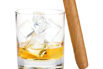 Whiskey glass and cigar. Isolated on white background