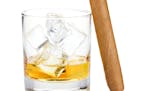 Whiskey glass and cigar. Isolated on white background
