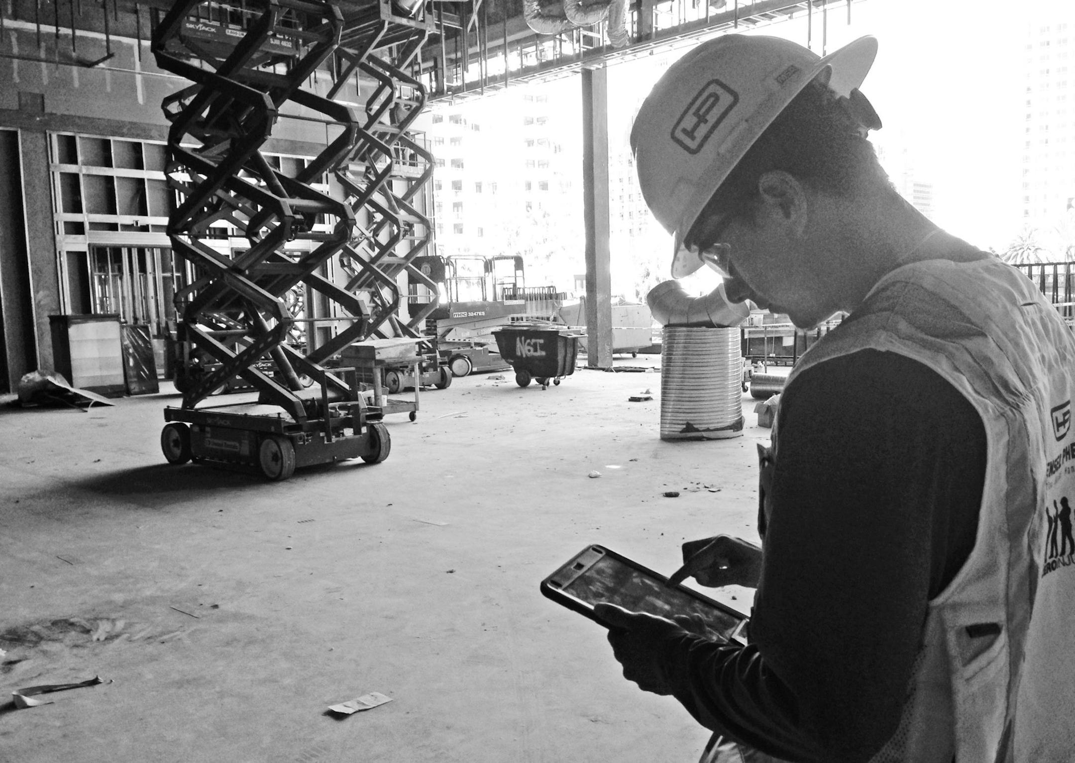 Hensel Phelps field engineer Andrew Coba notes progress on a tablet at the Intercontinental Hotel sight on the downtown San Diego waterfront. (Roger Showley/San Diego Union-Tribune/TNS)