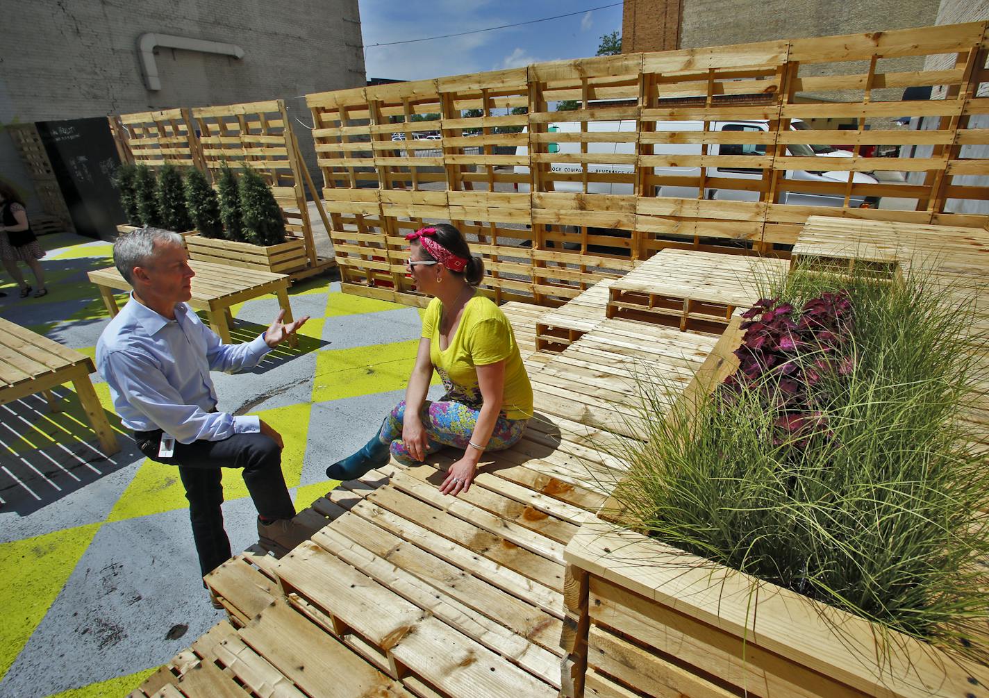 Tom Hock, CEO of Hennepin Theatre Trust, left and Joan Vorderbruggen in a pop-up park along Hennepin Ave. ] Joan Vorderbruggen works through Hennepin Theatre Trust to maximize local artists works by displaying them in empty Hennepin Ave. storefront windows and pop-up parks. (MARLIN LEVISON/STARTRIBUNE(mlevison@startribune.com)