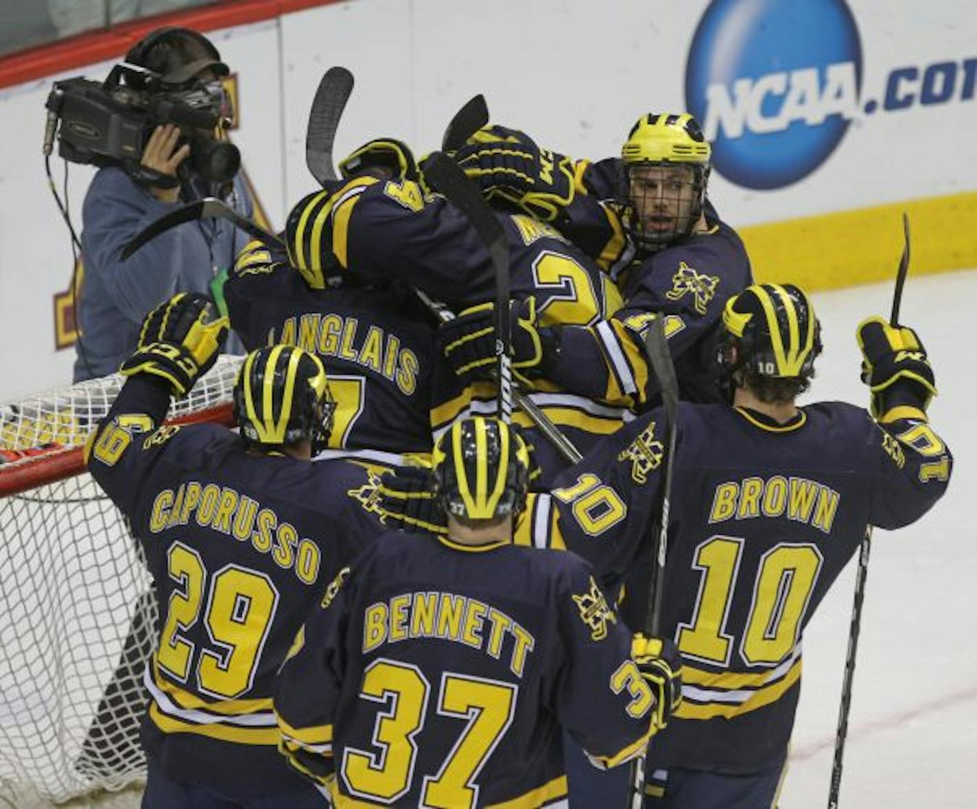 NCAA Frozen Four Semifinals, North Dakota vs Michigan. (left to right) Michigan celebrated their win over North Dakota.