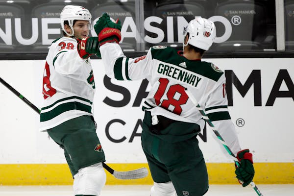 Wild left wing Ryan Hartman, left, celebrates his goal with left wing Jordan Greenway against the Anaheim Ducks during the first period