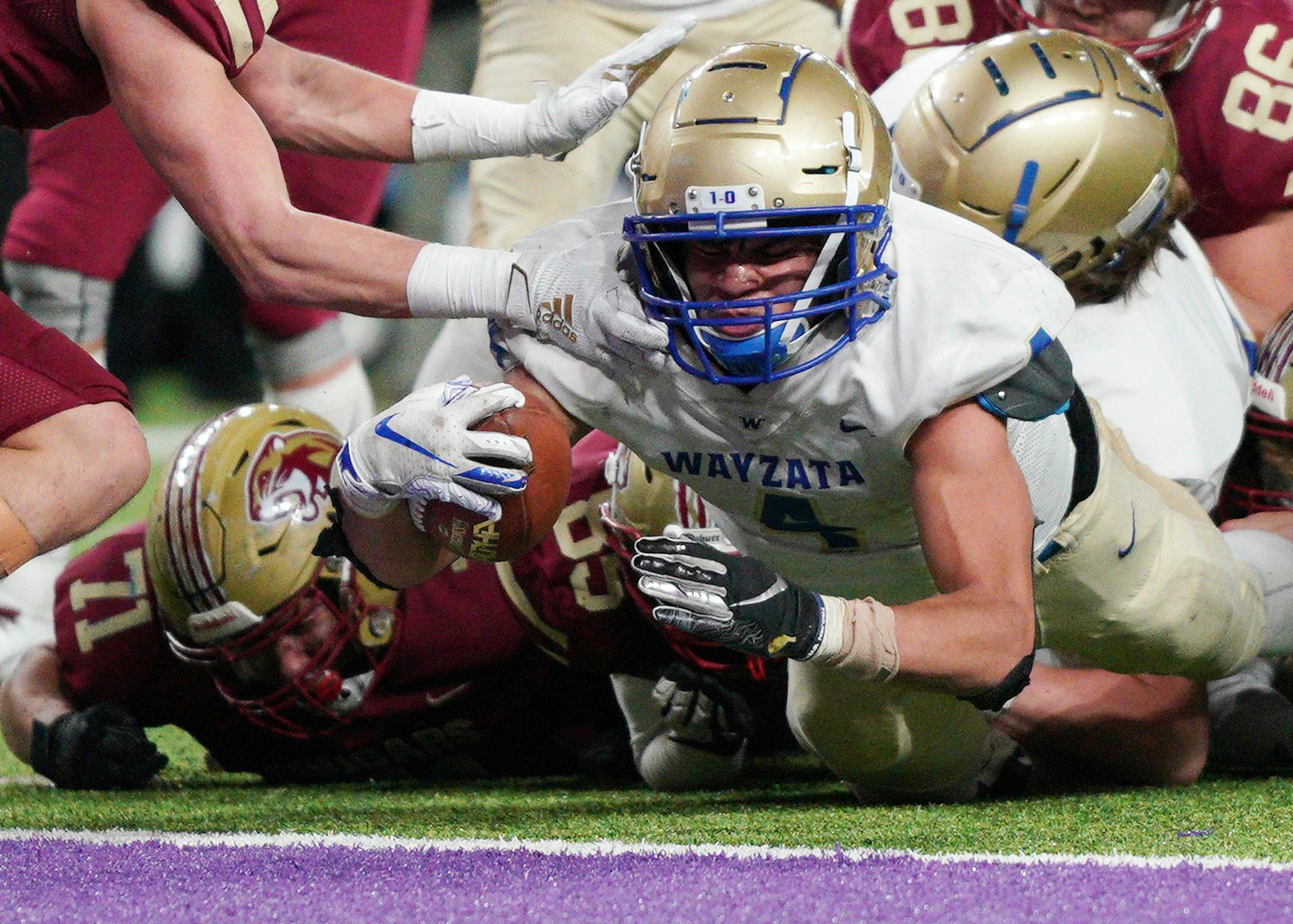 Wayzata running back Christian Vasser (4) dove into the end zone to score a touchdown in the first half. ] ANTHONY SOUFFLE &#x2022; anthony.souffle@startribune.com Wayzata played Lakeville South in a MSHSL Class 6A semifinal football game Friday, Nov. 15, 2019 at U.S. Bank Stadium in Minneapolis.