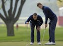 Europe�s Lee Westwood lines up a putt with Europe�s Thomas Pieters on the ninth hole during a foresomes match at the Ryder Cup golf tournament Fri