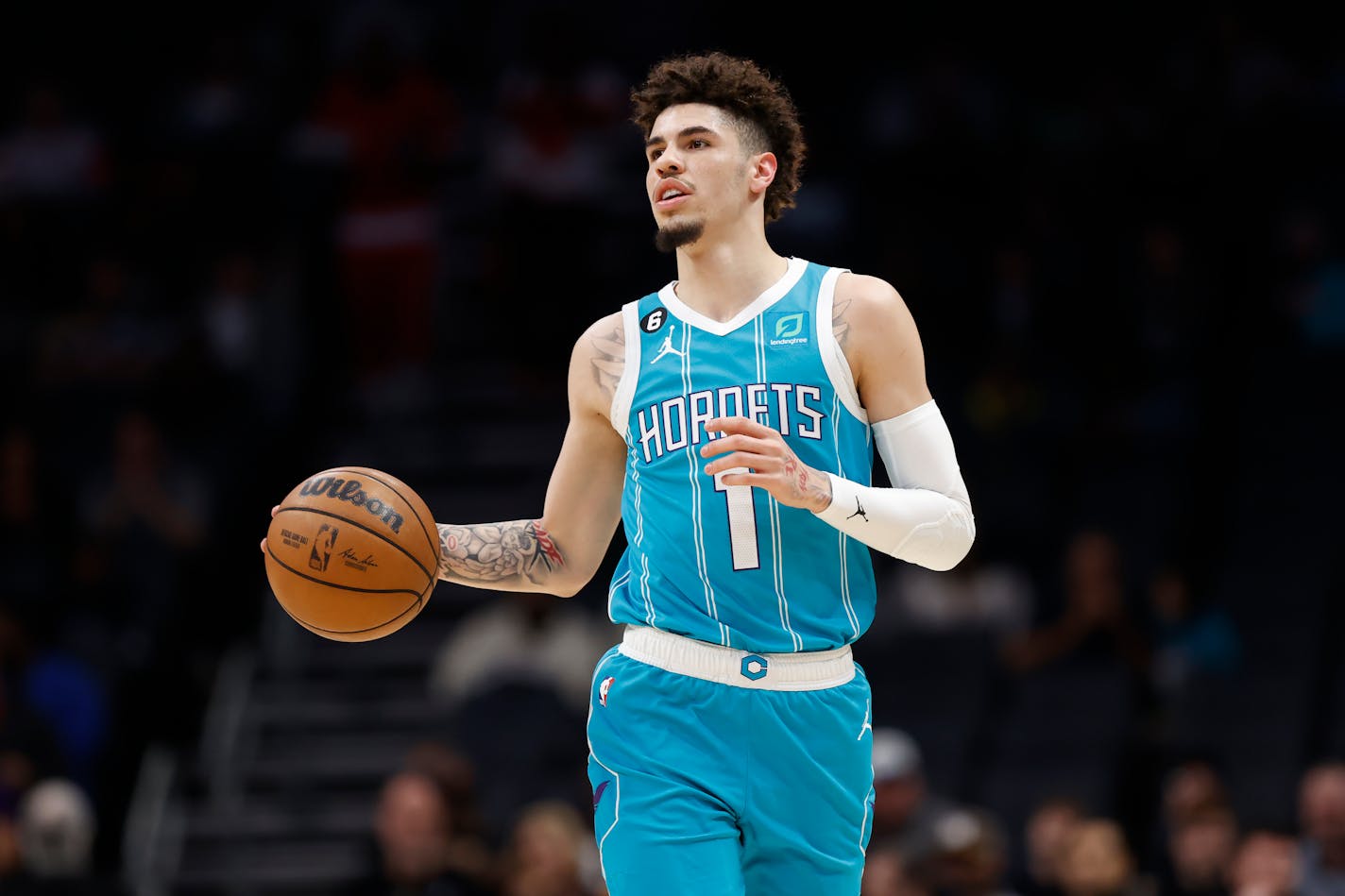 Charlotte Hornets guard LaMelo Ball brings the ball up during the first half of the team's NBA basketball game against the San Antonio Spurs on Wednesday, Feb. 15, 2023, in Charlotte, N.C. (AP Photo/Brian Westerholt)