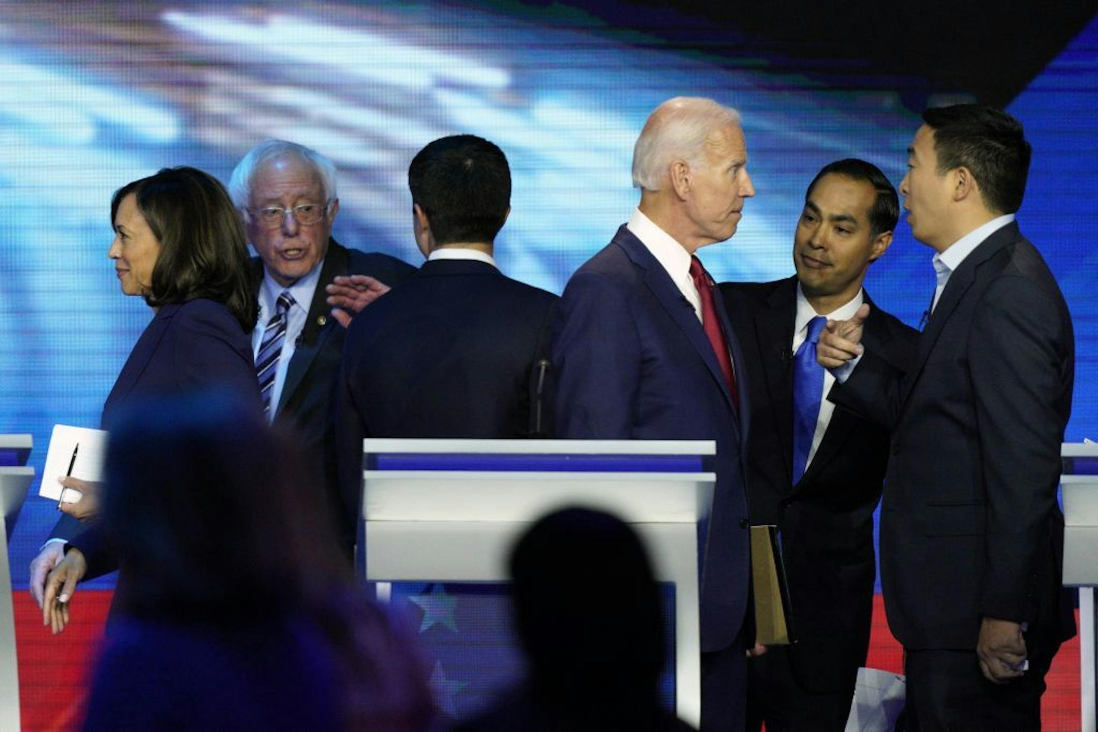 Democratic presidential candidates former Vice President Joe Biden, former Housing and Urban Development Secretary Julian Castro, and Andrew Yang, right, talk Thursday, Sept. 12, 2019, after a Democratic presidential primary debate hosted by ABC at Texas Southern University in Houston, as Sen. Kamala Harris, D-Calif., left, Sen. Bernie Sanders, I-Vt., and South Bend Mayor Pete Buttigieg talk.