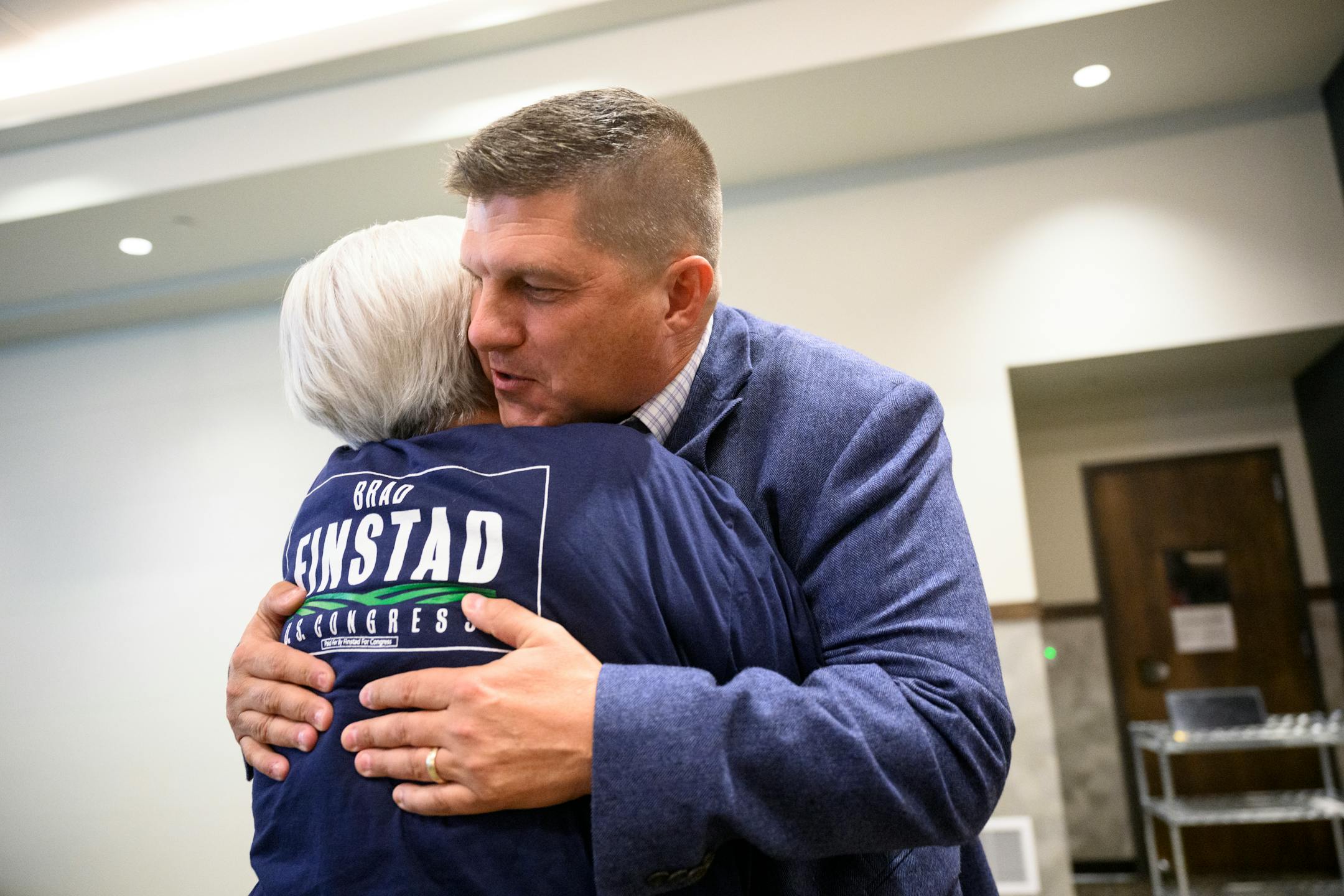 GOP congressional candidate Brad Finstad hugs his mother, Sharon Finstad, after Finstad gave a speech after his campaign announced his victory in the primaries during an election night party.